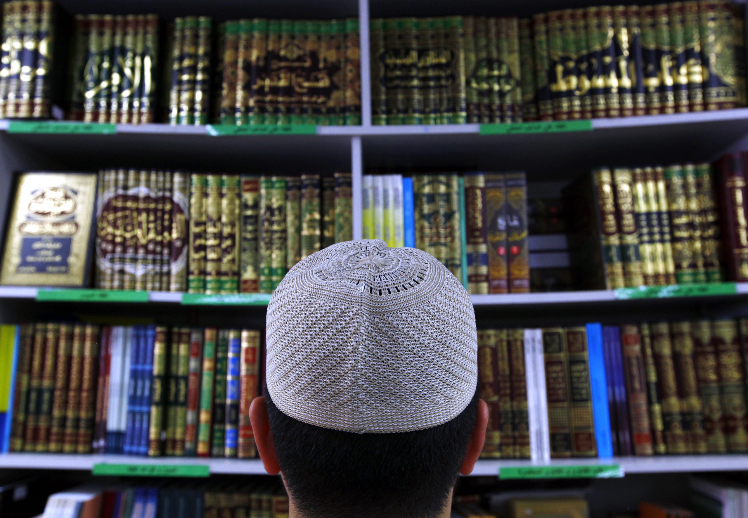 A man wearing an Islamic prayer cap, or 